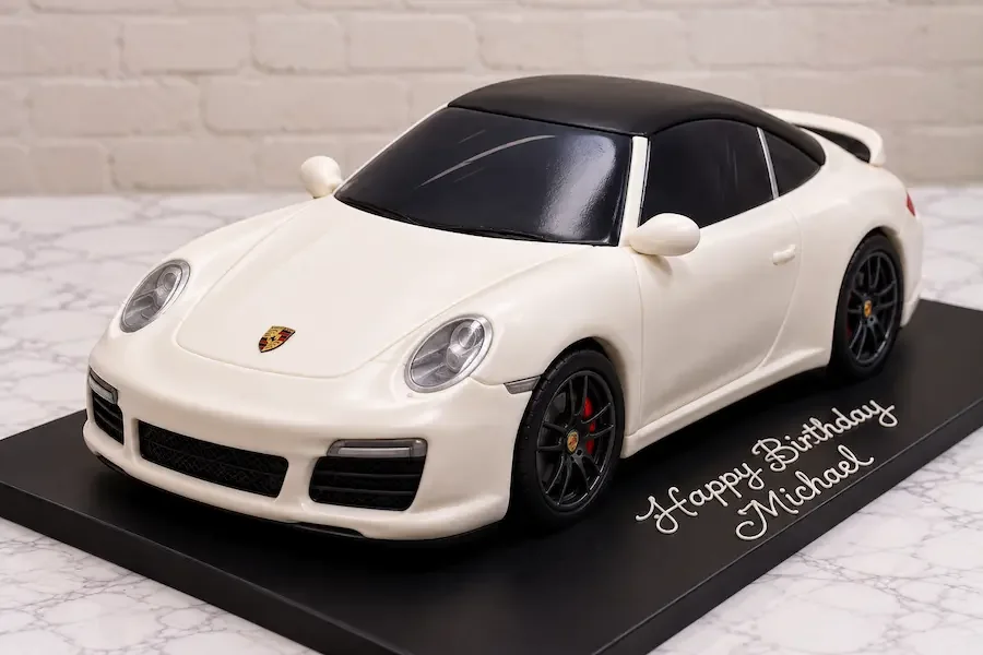 Sculpted sports car in white fondant with a black roof